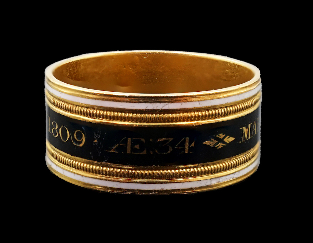 A George III 22ct gold and two colour enamel mourning band, inscribed 'Mary Powell OB. 12 Mar, 1809'